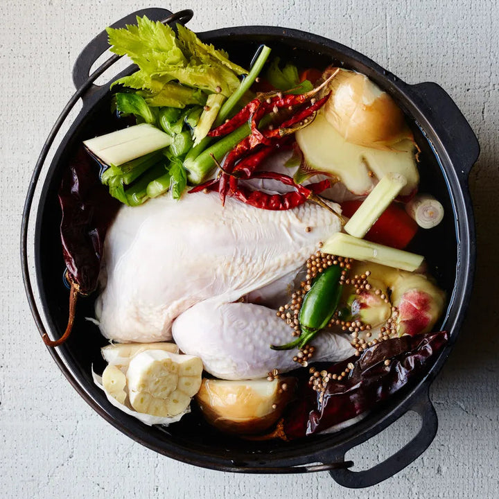 chicken and vegetables in a black pot