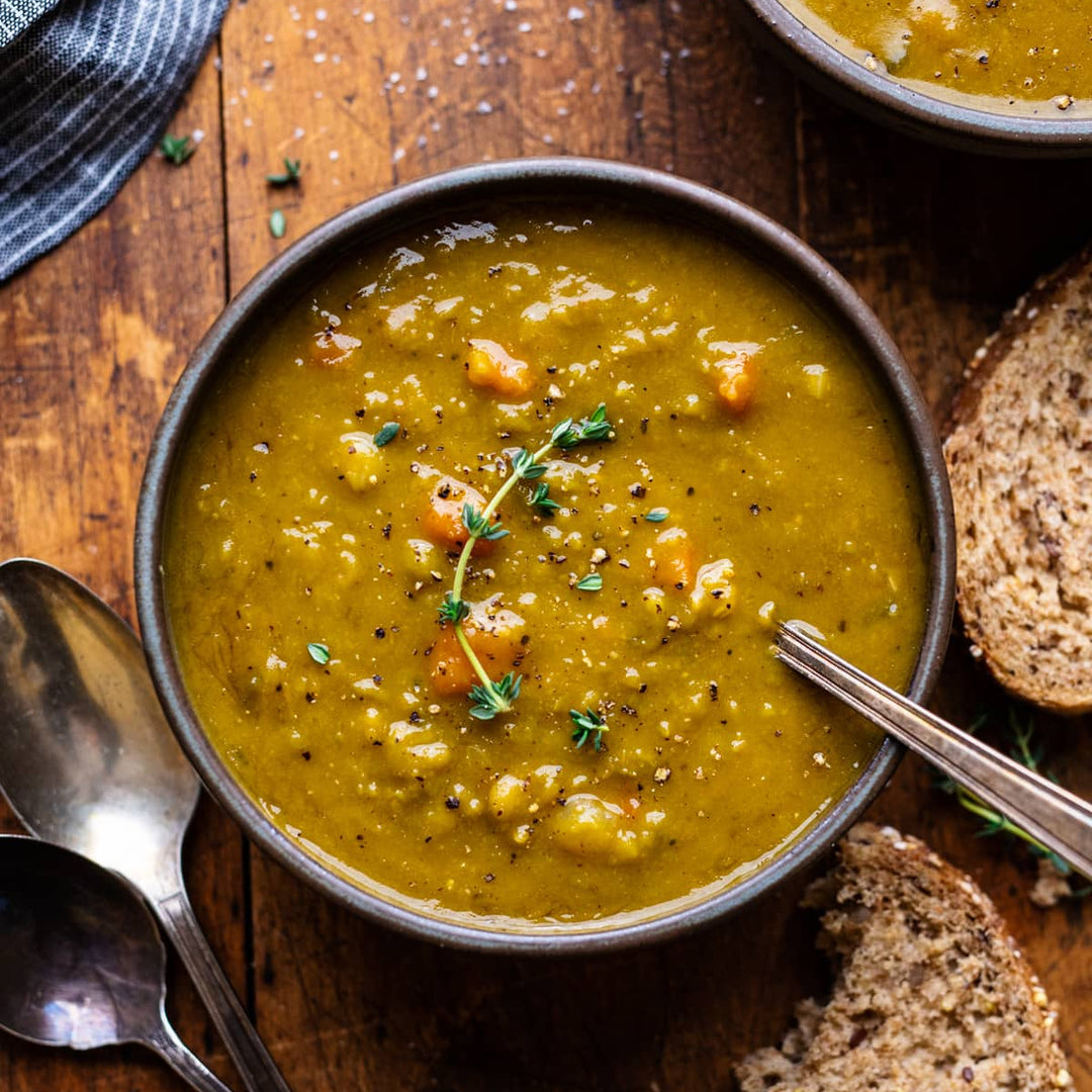 green split pea soup on a dark wooden table