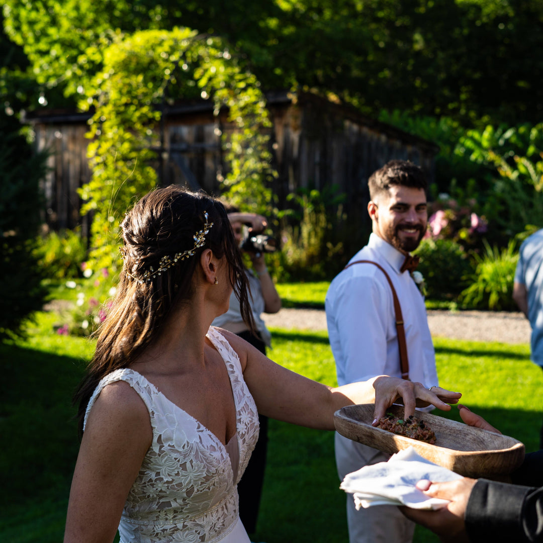 a wedding couple happily gaze at each other while the bride reaches for delicious urban element food.